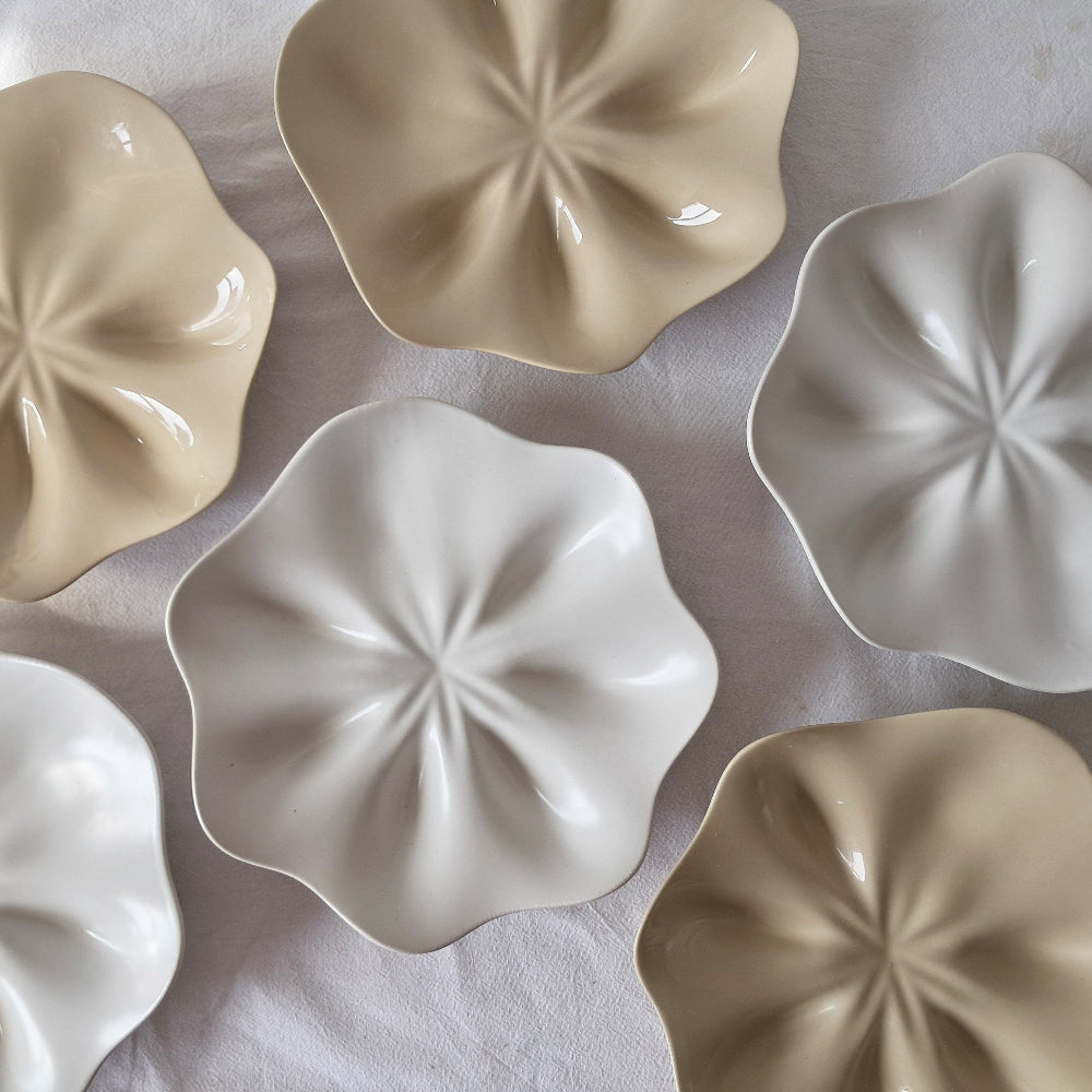 Ceramic ERRJ Half dozen oyster plates on a white tablecloth, satin white and clear natural finish